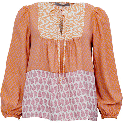 <p>Channel your boho vibes with the Costamani Reema Shirt in vibrant orange. This playful blouse features a mixed print inspired by Moroccan designs, adding a fun and eclectic touch to your wardrobe. Perfect for adding some colour and personality to any outfit!</p> <p>&nbsp;</p> <p data-mce-fragment="1">Made of <span data-mce-fragment="1">84% rayon, 16% nylon</span>, machine wash 30&nbsp;</p>