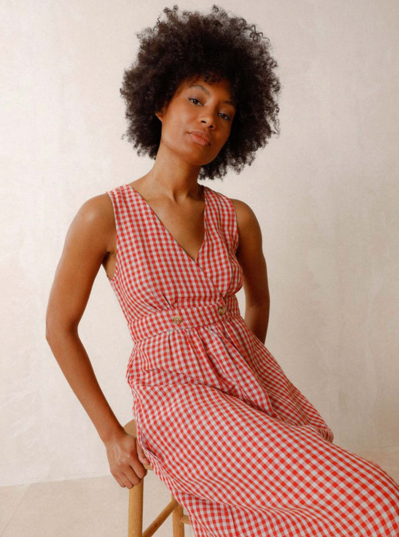 <p>This Rojo gingham dress features a playful crossover V-neck and a flattering a-line silhouette. Part of Indi &amp; Cold&