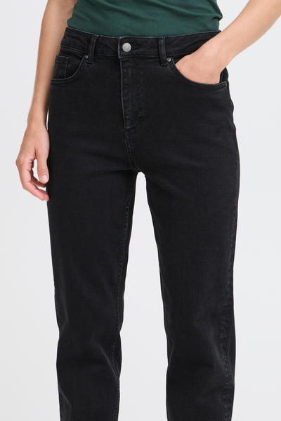Person wearing BY Loetta black jeans on a plain background