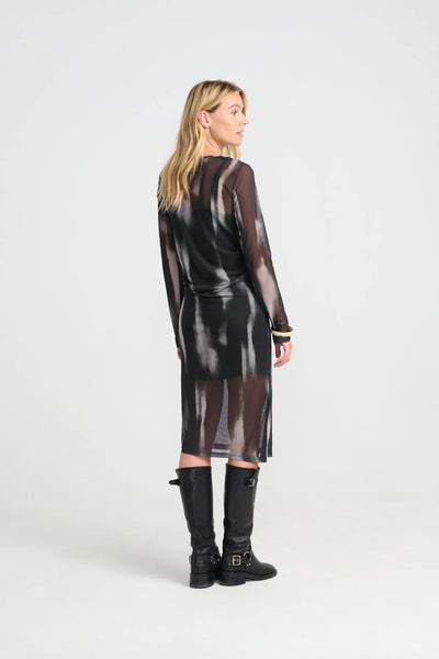 Woman wearing costamani black brown sheer dress with a leather texture on a white background
