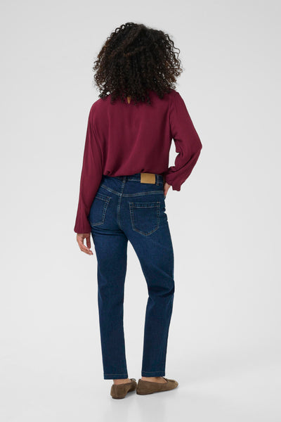 Back view of Person wearing a burgundy shirt and blue jeans on a white background