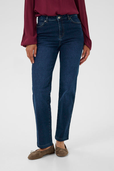 Person wearing blue jeans and a burgundy top on a white background