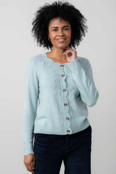 Woman wearing lily & me light blue cardigan against a plain background