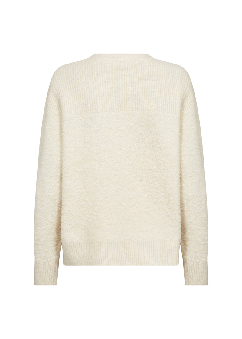Cream-colored sweater on a white background