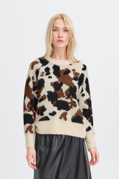 Woman wearing a cow print sweater  with black skirt