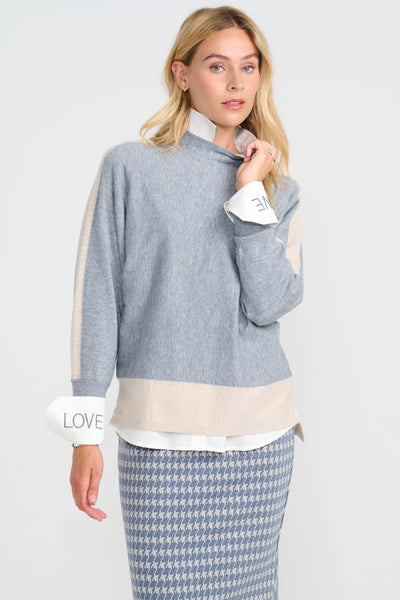 Woman wearing costamani gray sweater with a white shirt and plaid skirt 