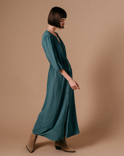 Watch your style take flight! The Laurence Maxi Dress by Grace & Mila is a dreamy blue vision of fashion. Featuring a relaxed fit, dusty teal hues, tie waist, and short puffed sleeves, it'll help you channel your inner mermaid! Float through any room in style.   Made of 100% Polyester, wash at 30 degrees and air dry where possible