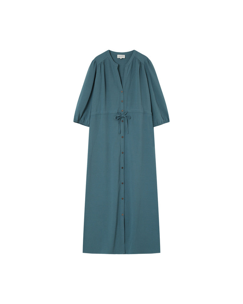 Watch your style take flight! The Laurence Maxi Dress by Grace & Mila is a dreamy blue vision of fashion. Featuring a relaxed fit, dusty teal hues, tie waist, and short puffed sleeves, it&