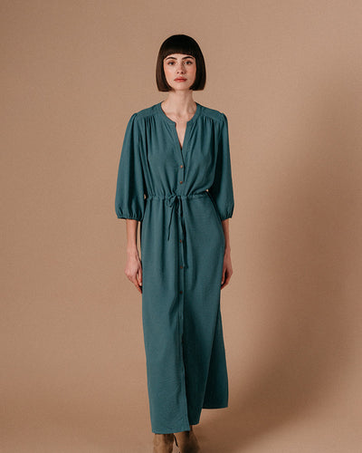 Watch your style take flight! The Laurence Maxi Dress by Grace & Mila is a dreamy blue vision of fashion. Featuring a relaxed fit, dusty teal hues, tie waist, and short puffed sleeves, it'll help you channel your inner mermaid! Float through any room in style.   Made of 100% Polyester, wash at 30 degrees and air dry where possible